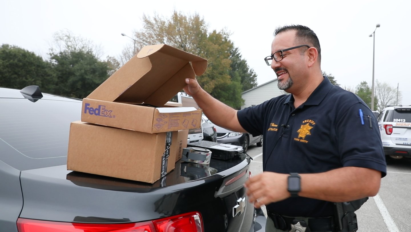 An HCSO investigator works with equipment used to capture “porch pirates.” The term is used to describe thieves who steal packages from porches.